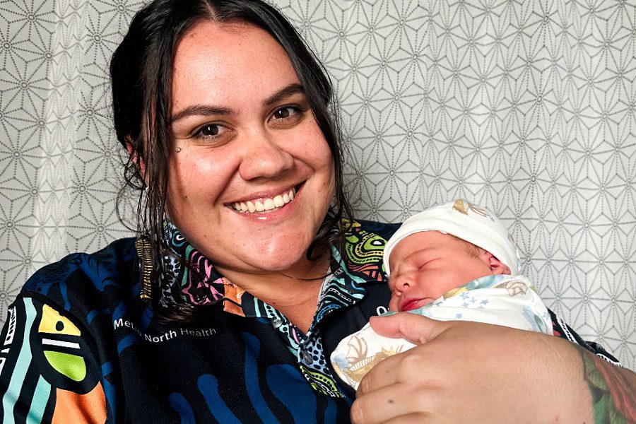 Ngarrama Redcliffe Aboriginal and Torres Strait Islander Health Worker, Angel Sellars, pictured with a newborn.