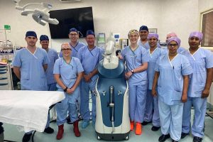 Members of the Orthopaedic Surgical team with the robotic arm