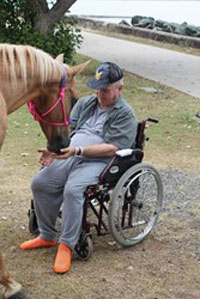 Gannet House resident enjoying a visit from Faith the mare