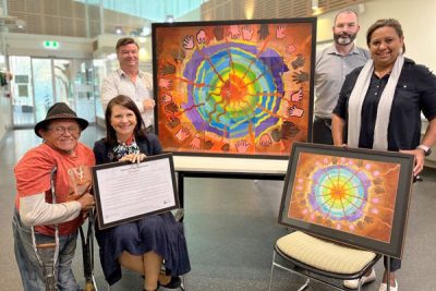 Angie Dobbrick receiving Aboriginal and Torres Strait Islander artwork for Caboolture Hospital 