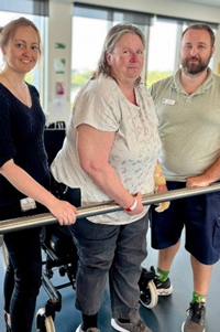 Sharon, stroke patient pictured with physios Amy and Fin.
