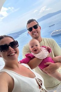 Holiday snap of Emma Cooper with husband holding baby Lyla