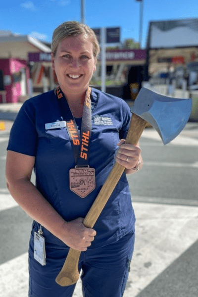 Katrina Cook, elective surgery coordinator at Caboolture Hospital, hold her competition woodchopping axe