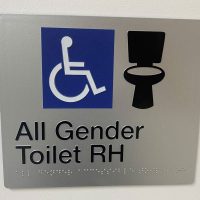 Signage for gender-inclusive bathroom at TPCH