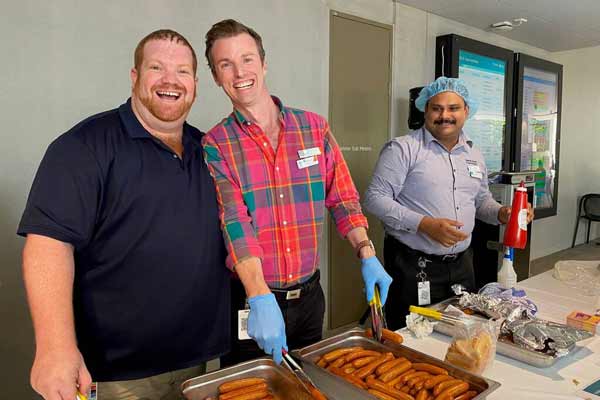 Staff Council co-chairs Ben Frost and Ollie Mason and Staff Council member Kiran Paul serving at the Staff BBQ 