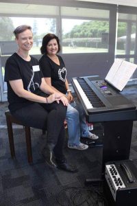 Katie Lawton and Althea O'Dee sitting at electronic keyboard