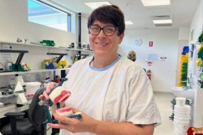 Kris Patterson, Dental Technician at Caboolture Satellite Hospital holding set of dentures