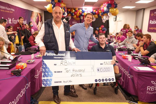 RBWH Foundation Giving Day event with large donation cheque in the foreground