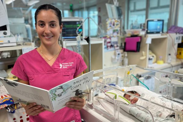 Nurse Bec reading to Lenny, showing RBWH's commitment to holistic care.