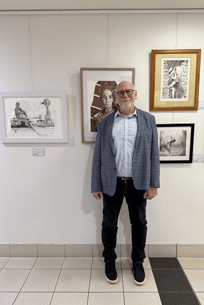 RBWH Executive Support Officer Mark Pearson standing in front of his stipplings and line drawings