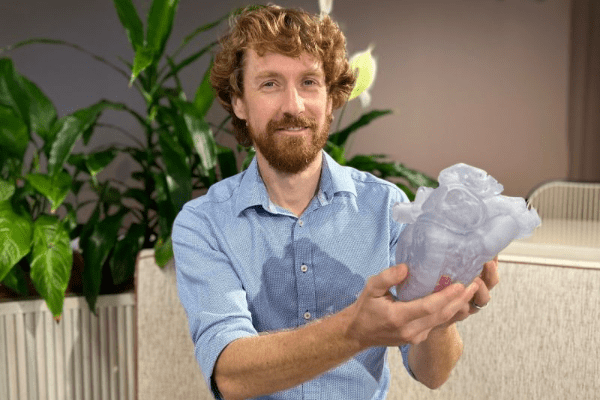 man holding 3D printed heart