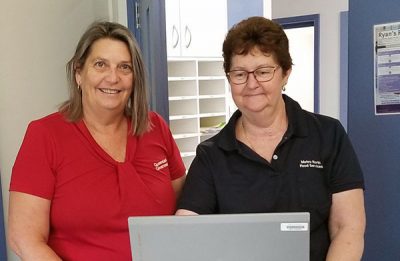 Caboolture Hospital Dietetic Assistant Sharmaine McBain and Kilcoy Hospital Cook Kathy Ellem collecting lunch orders using the computer workstation on wheels.