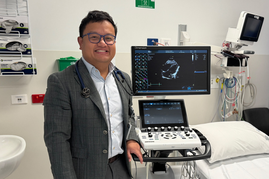 Dr Pyi Naing with an Echocardiogram Machine