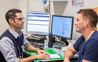 Doctor with patient at computer