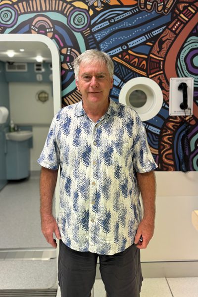 Bob Campbell stands in front of the RBWH hyperbaric chamber