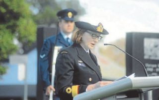 Dr Elizabeth Rushbrook in uniform at lecturn
