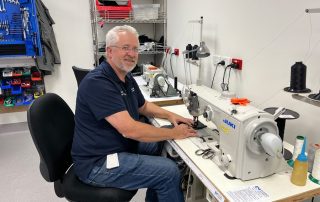 Alan working on an upholstery task at the Rehabilitation Engineering Centre at STARS.