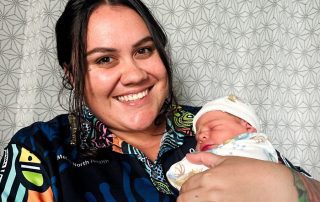 Ngarrama Redcliffe Aboriginal and Torres Strait Islander Health Worker, Angel Sellars, pictured with a newborn.