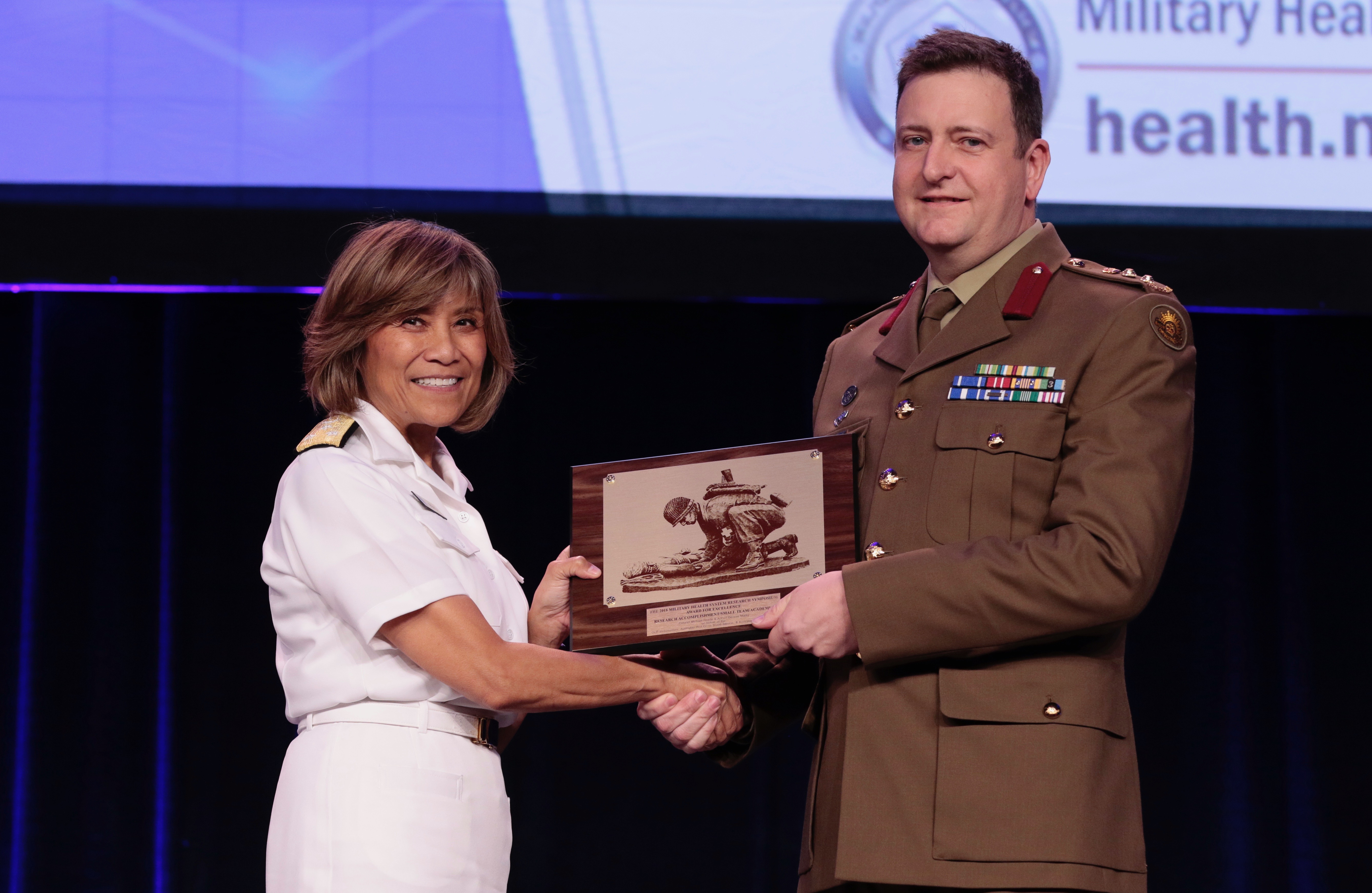 Professor Michael Reade accepting the award at the US Military Health System Research Symposium in Orlando, Florida.