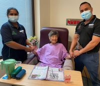 Two health professionals with elderly patient