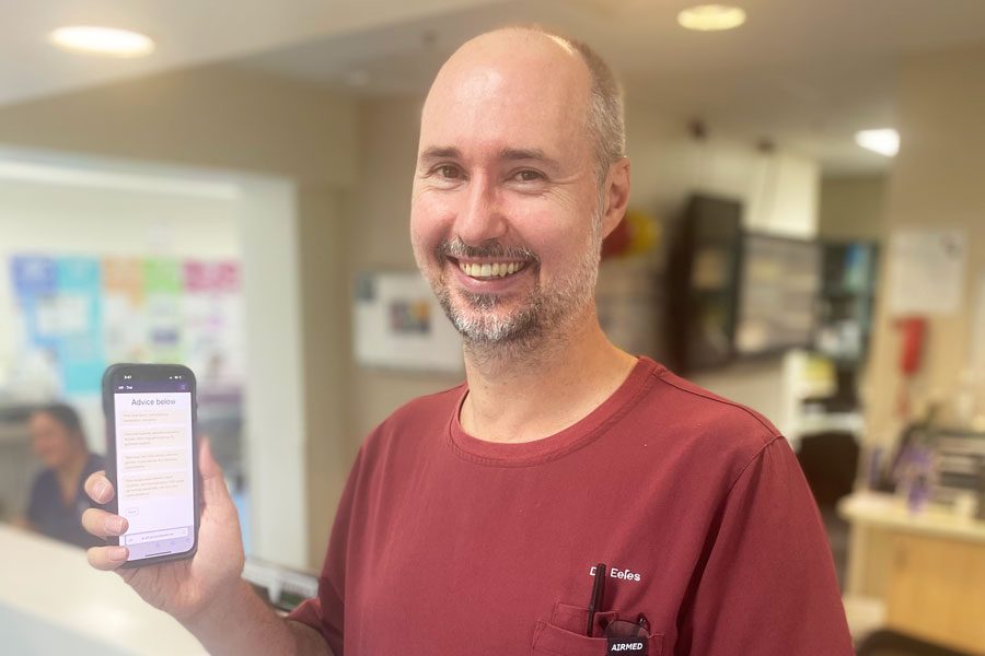 The Prince Charles Hospital Geriatrician Dr Eamonn Eeles holding mobile phone