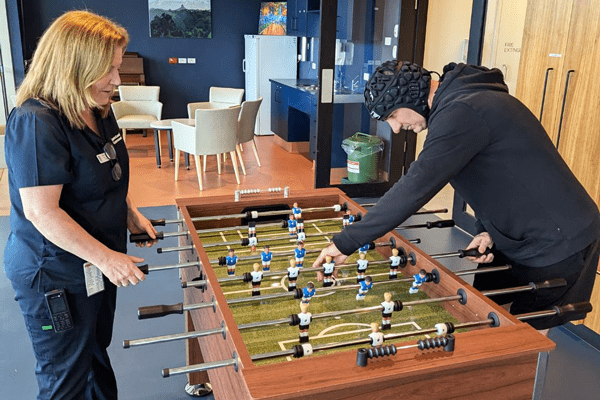 STARS Nurse Unit Manager Deborah and patient Stuart have a game of foosball