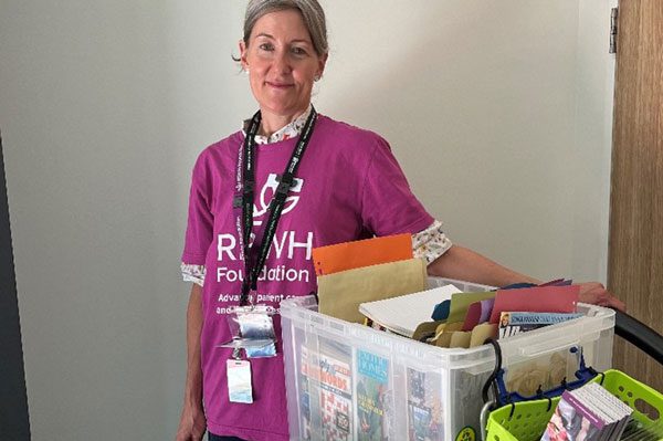 RBWH Foundation volunteer Annie with 'Bluey' the reading trolley at STARS.