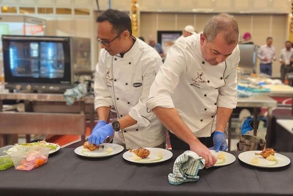 Rajesh and Bredan competing in the 2024 Institute of Hospitality in HealthCare (IHHC) Culinary Competition.