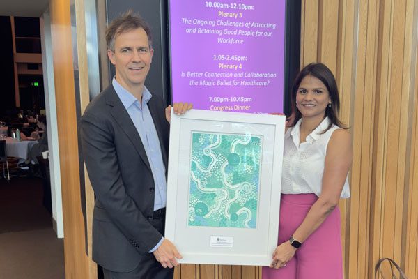 Professor Peter Hopkins and Archana Mishra receive their award