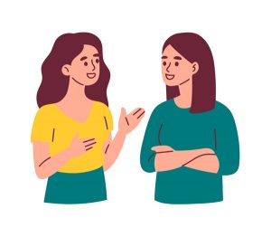 Two women talking to eachother and smiling