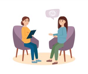 Two women sitting in chairs and one women is talking about a problem