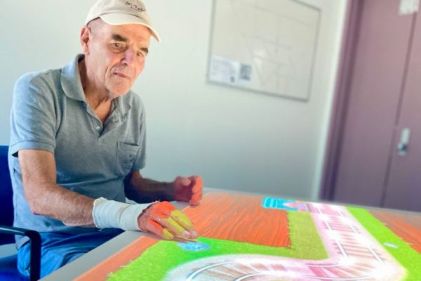 Patient Robert enjoying the interactive ToverTafel table in the Cognitive Assessment and Management (CAM) Unit at The Prince Charles Hospital.