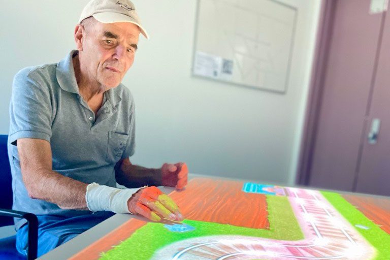 Patient Robert enjoying the interactive ToverTafel table in the Cognitive Assessment and Management (CAM) Unit at The Prince Charles Hospital.