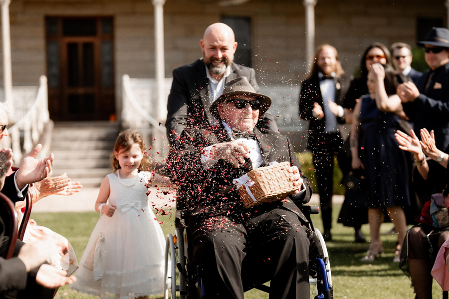 Roy taking on 'flower girl' duties at his grand daughter's wedding thanks to his customised wheelchair seating.
